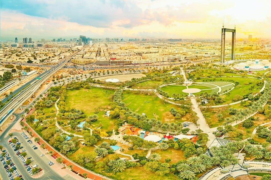Dubai Frame rising above Zabeel Park in a wide aerial view