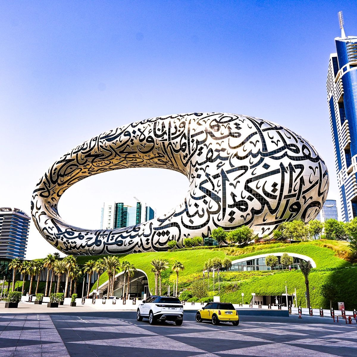 Museum of the Future exterior with Dubai skyline and landscaped surroundings