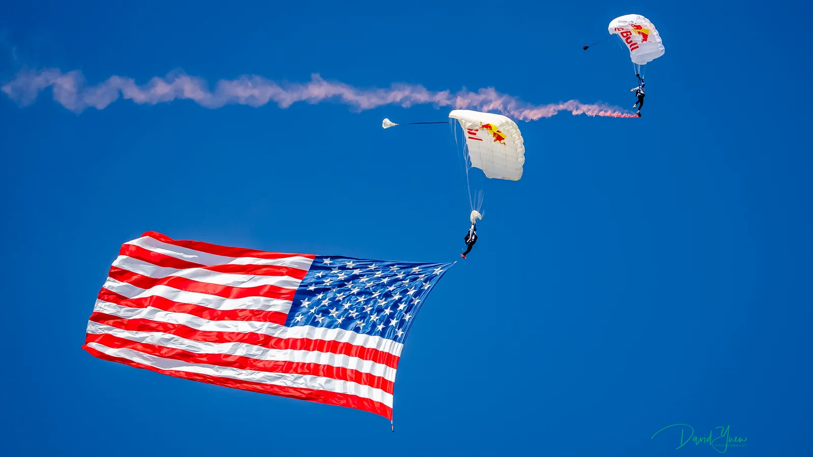 Parachutists carrying a large United States flag above Circuit of The Americas during the 2021 United States Grand Prix