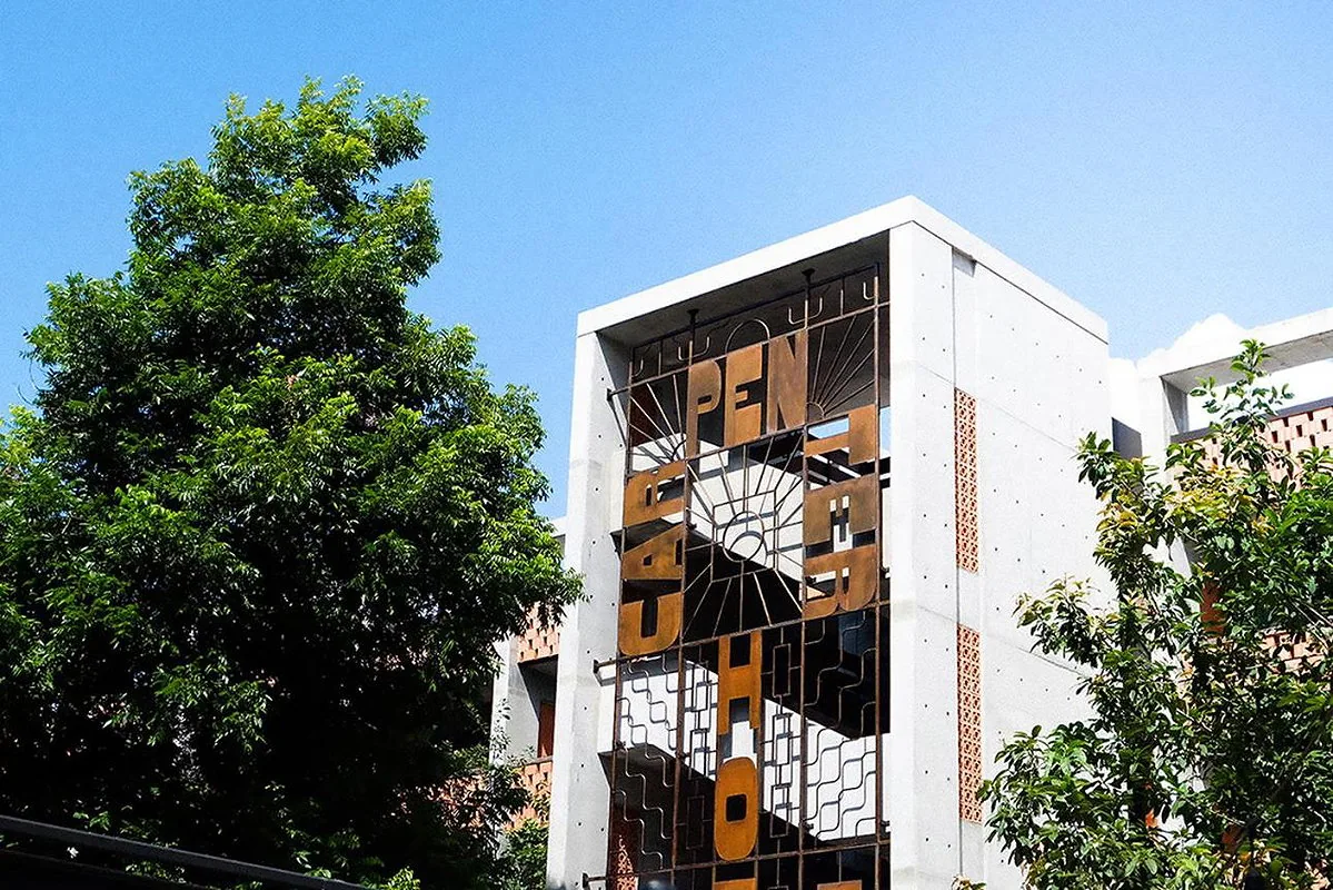 Tree-framed exterior of The Carpenter Hotel, a premium South Austin hotel option for Grand Prix weekend